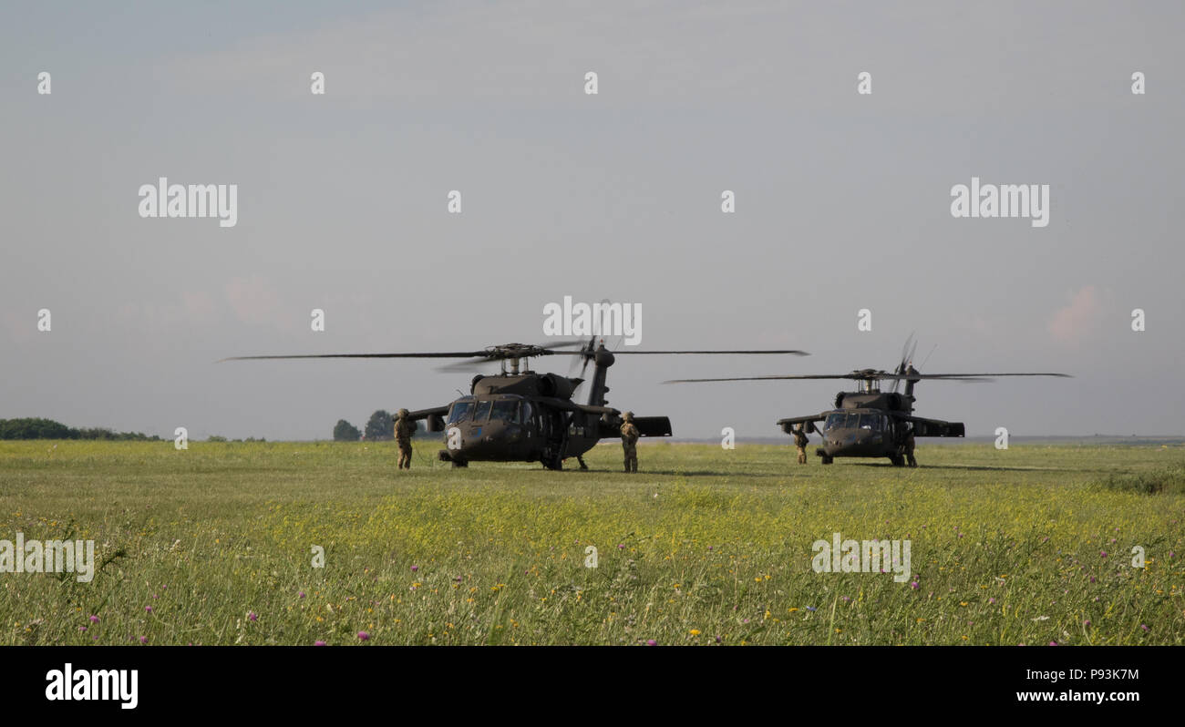 U.S. Soldiers assigned to the 2nd General Support Aviation Battalion, 4th Aviation Regiment, 4th Combat Aviation Brigade, 4th Infantry Division, prepare for air assault training using their UH-60 Blackhawks near Mihail Koglniceanu Air Base, Romania, July 10, 2018. The Soldiers of 2nd GSAB are conducting similar training in multiple locations throughout Europe in support of Atlantic Resolve, a U.S. endeavor to fulfill NATO commitments by rotating U.S.-based units throughout the European theater to deter aggression against NATO allies and partners in Europe. (U.S. Army photo by Spc. Andrew McNei Stock Photo