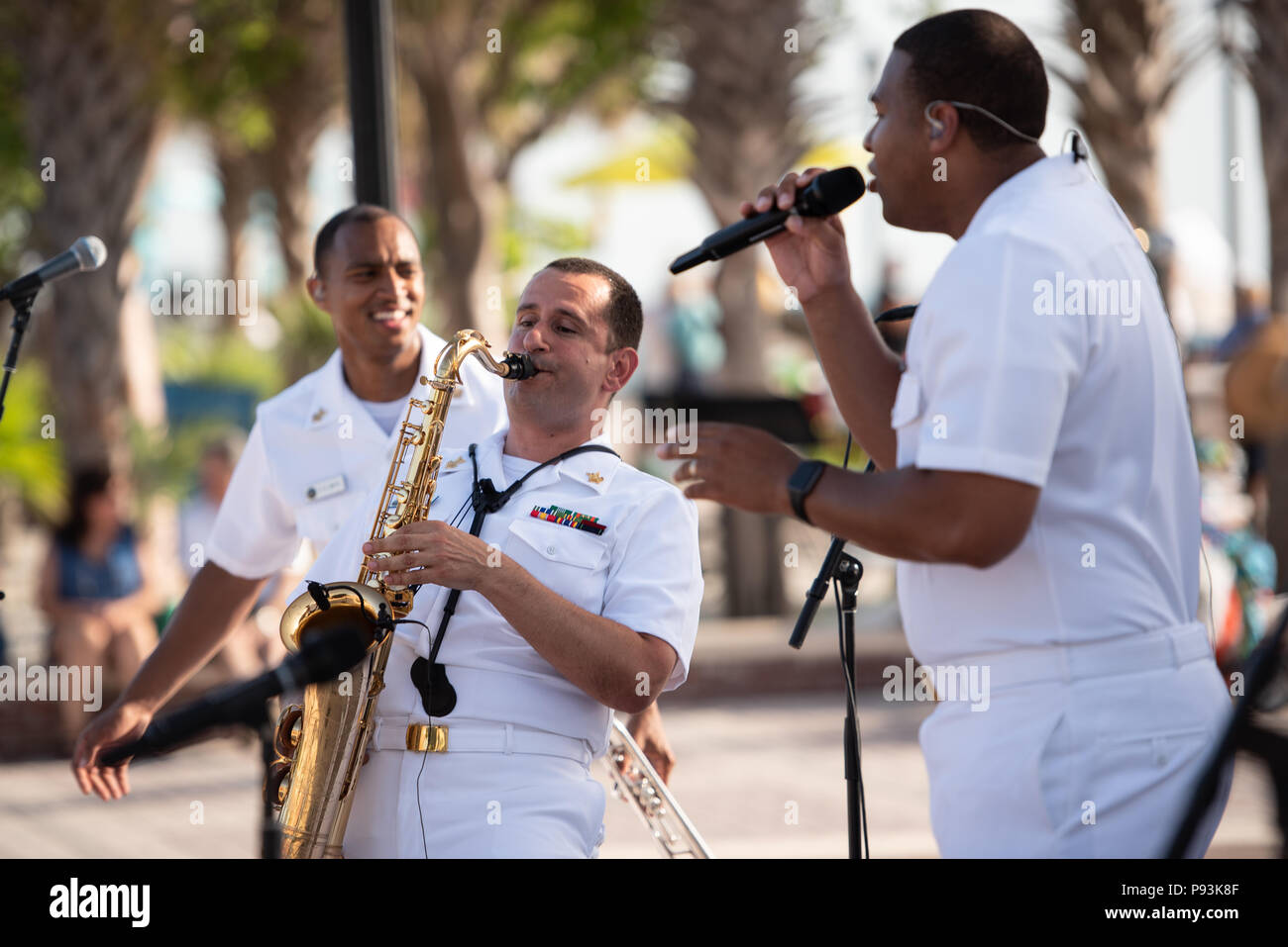 KEY WEST, Fla. (July 9, 2018) Musicians 1st Class David Smith, left, Manuel Pelayo de Gongora, center, and Cory Parker, right, perform with the U.S. Navy Band Cruisers popular music group during a concert at Mallory Square in Key West, Fla. The Navy Band performed in seven cities in Florida, connecting communities to the Navy and building awareness and support for the Navy. (U.S. Navy photo by Senior Chief Musician Adam Grimm/Released) Stock Photo