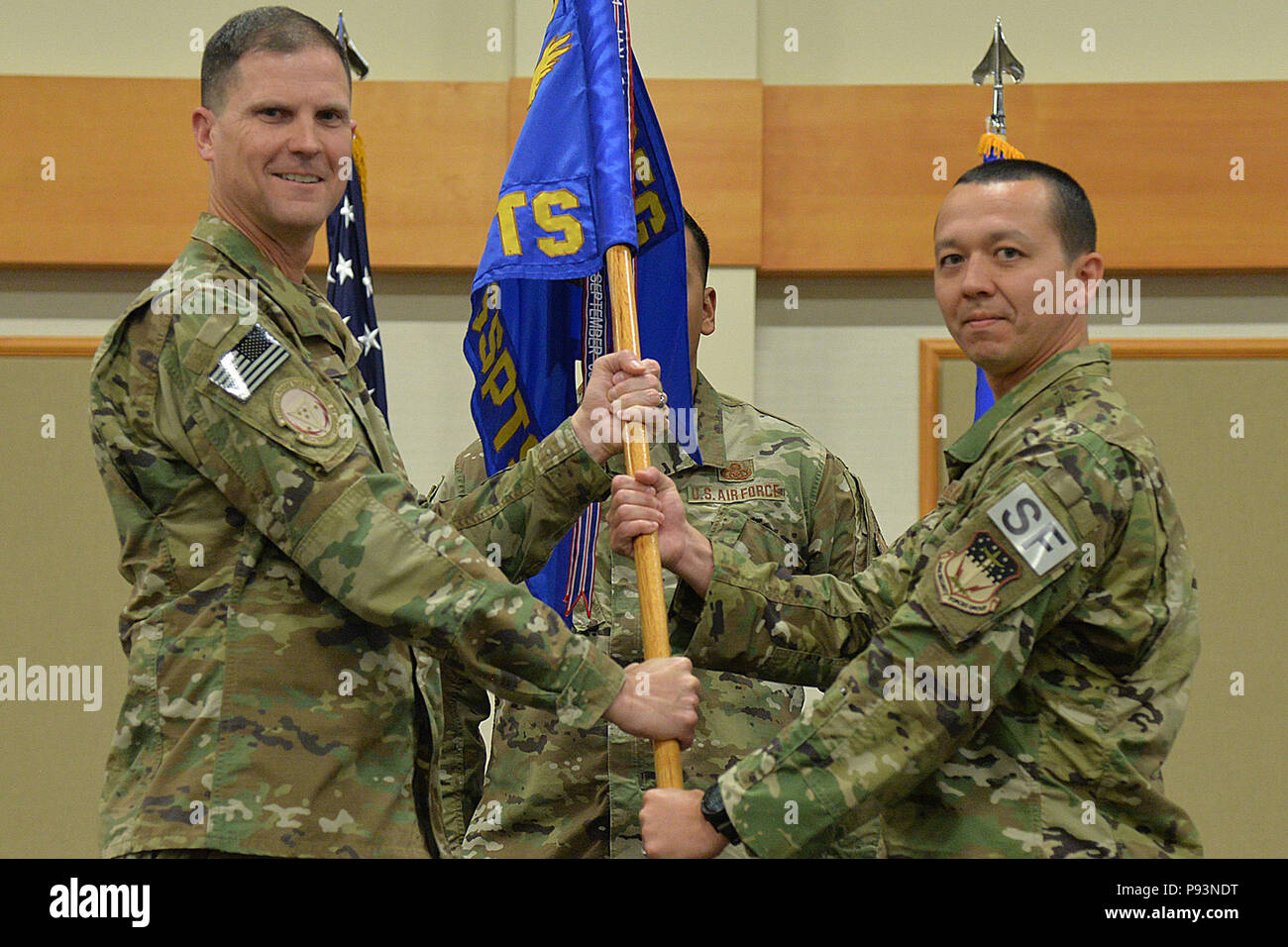 Maj. Tito Ruiz, right, accepts command of the 1341st Security Support Squadron from Col. Aaron Guill, 341st Security Forces Group commander during a change of command ceremony July 12, 2018, at the Grizzly Bend on Malmstrom AFB, Mont. Guidon bearer Master Sgt. Alejandro Torres, 341st SSPTS first sergeant, looks on. (U.S. Air Force photo by A1C Jacob M. Thompson) Stock Photo