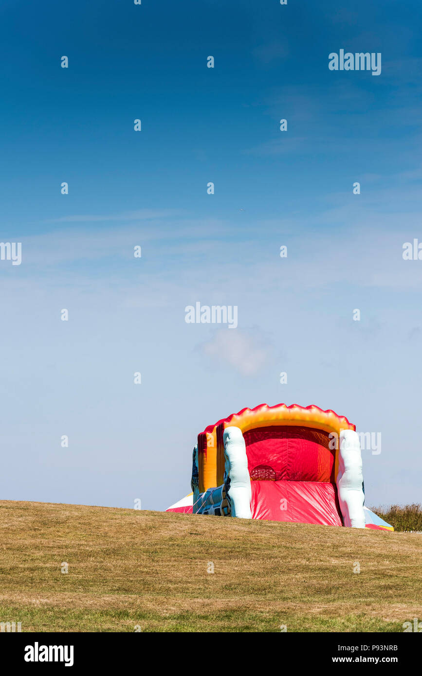 A large colourful bouncy castle on Barrowfields in Newquay in Cornwall. Stock Photo