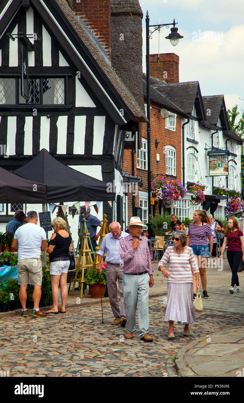 People men and women enjoying the summer sunshine at the local produce farmers market  in the market town of Sandbach  Cheshire England UK Stock Photo
