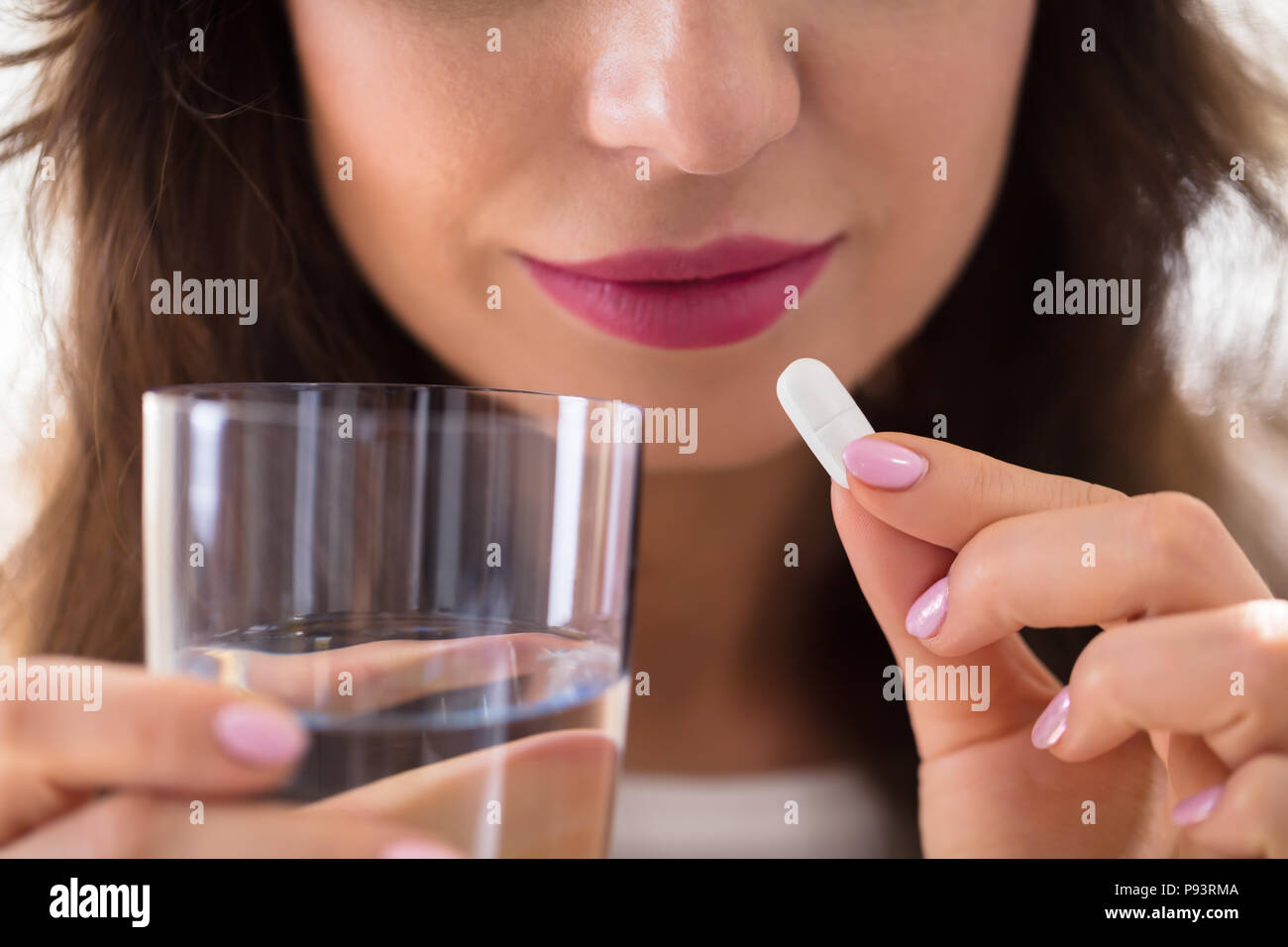 Close-up Of A Businesswoman's Hand Taking Pill Stock Photo
