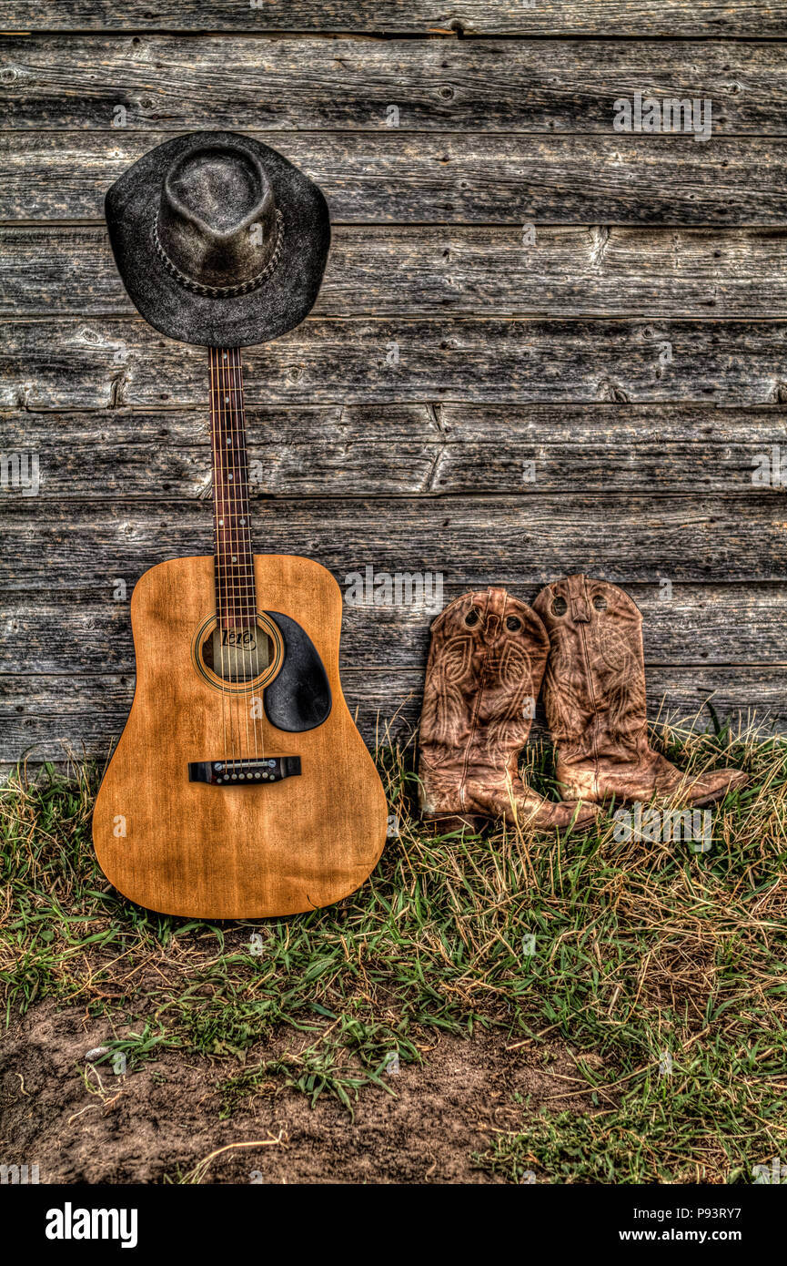 Acoutic guitar, cowboy hat, cowboy boots and old, aged farm shed wall.  Rural Alberta, Canada Stock Photo - Alamy