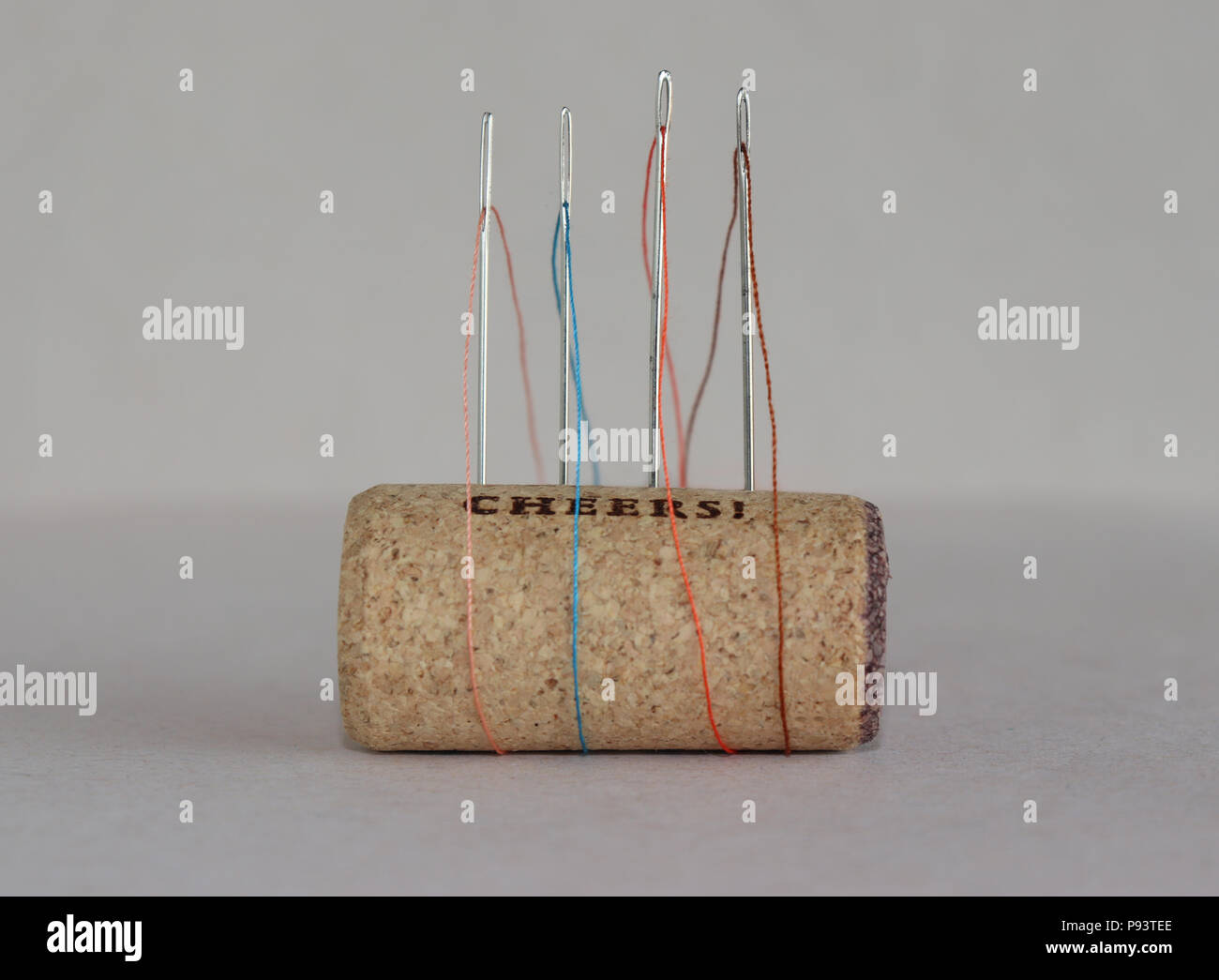 Threaded needles stuck in a wine cork Stock Photo Alamy
