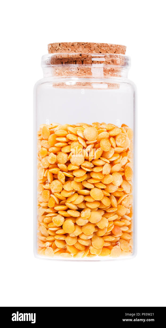 Dried yellow peas in a glass bottle with cork stopper, isolated  Stock Photo