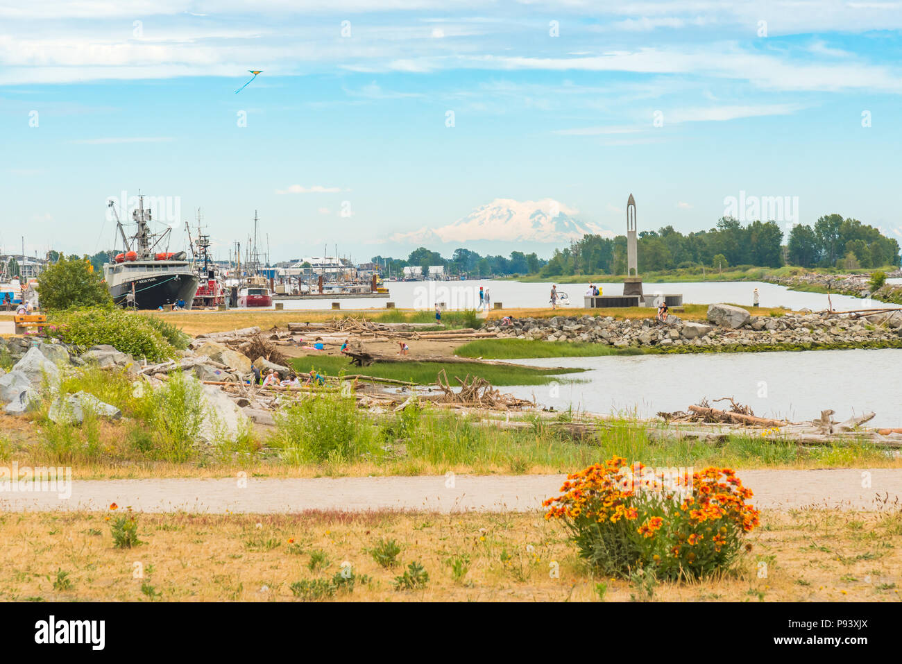 RIchmond, British Columbia/Canada - June 24, 2018: families walk, fly kites, and play together on the beach at Garry Point Park in summer, a popular p Stock Photo