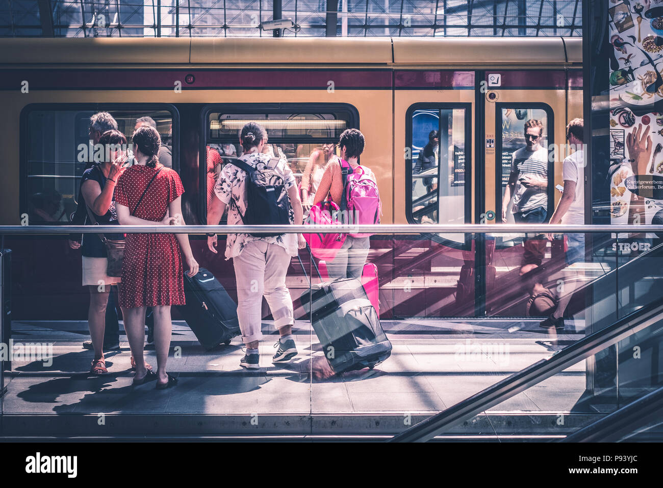 Berlin, Germany - july 2017: Traveling people with luggage at train station platform at  main station (Hauptbahnhof)   in Berlin, Germany Stock Photo