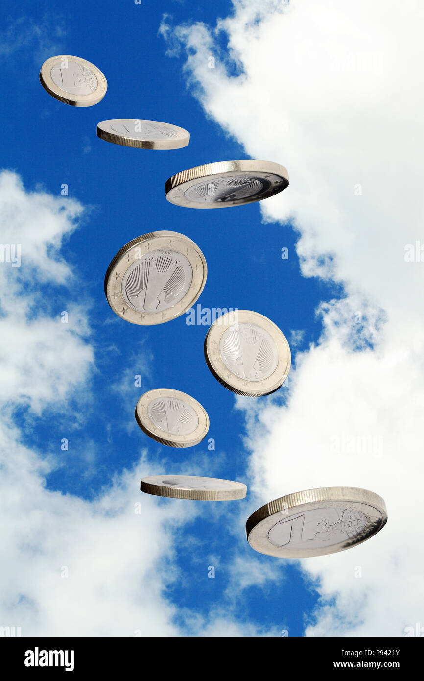 One euro coin flying on blue sky background. Object with clipping path Stock Photo
