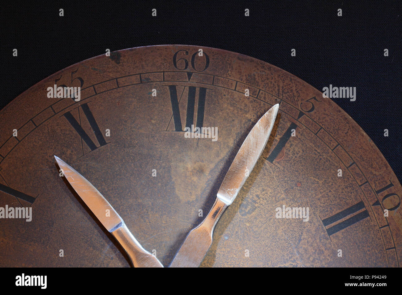 Closeup of old rusty bronze clock dial. Clock hands made from sharpen