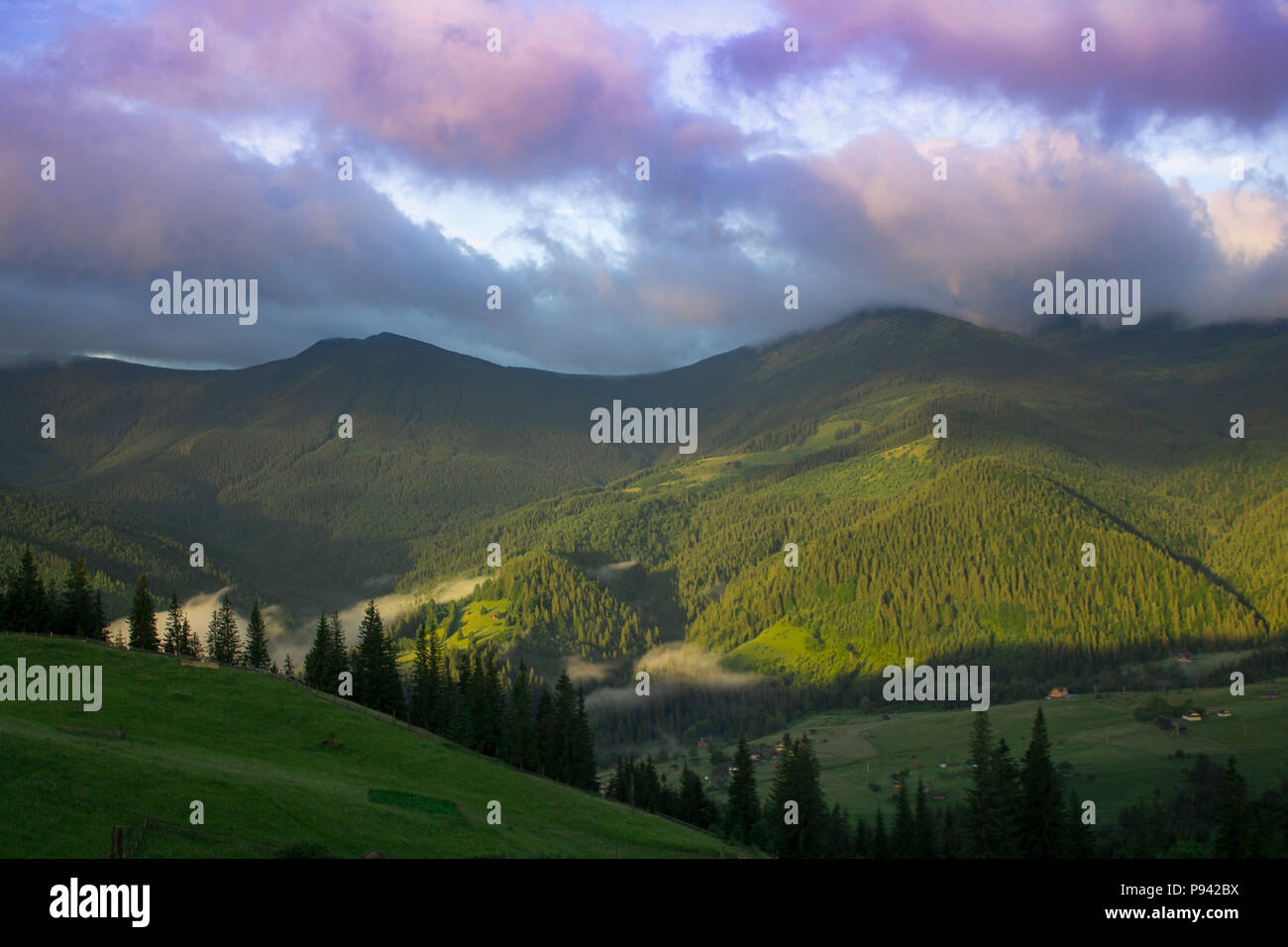 Photo of mountain landscape in the summer under beautiful cloudy sky. Ukraine, Carpathians, Dzembronia village Stock Photo