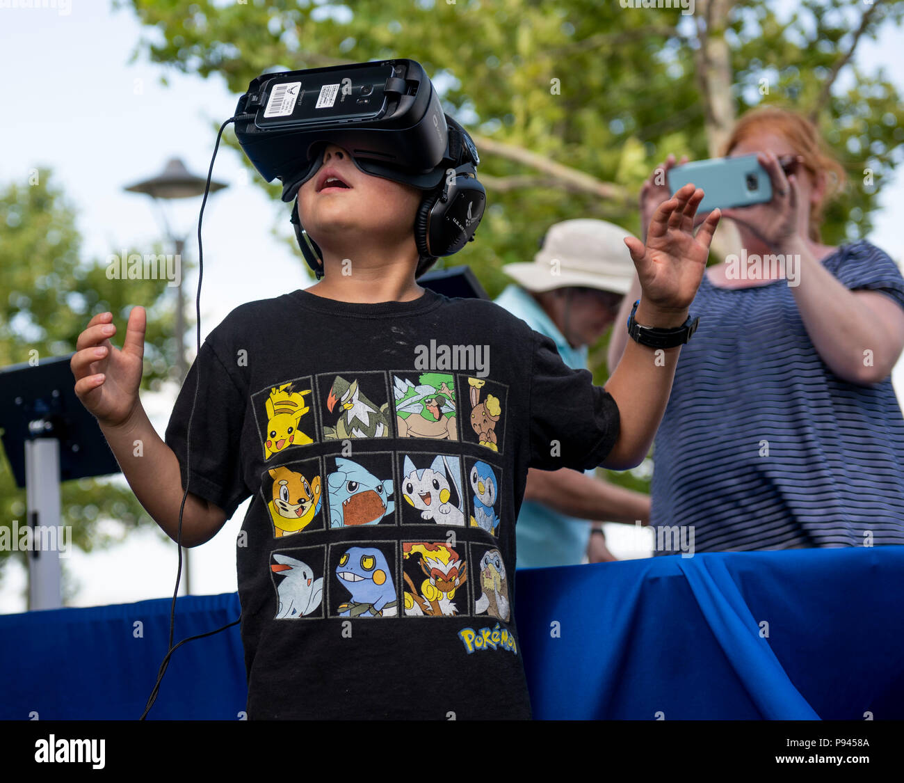 A young boy tests virtual reality goggles at an Air Force Recruiting