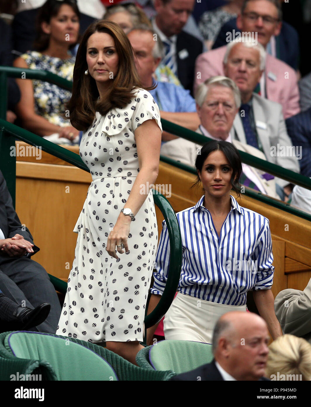 The Duchess of Cambridge and the Duchess of Sussex in the royal box on centre court on day twelve of the Wimbledon Championships at the All England Lawn Tennis and Croquet Club, Wimbledon. Stock Photo