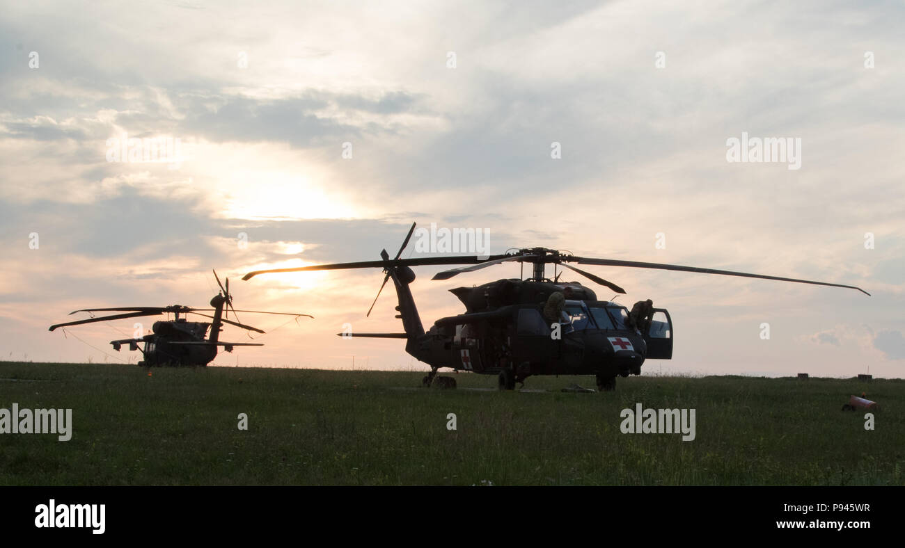 U.S. Soldiers assigned to the 2nd General Support Aviation Battalion, 4th Aviation Regiment, 4th Combat Aviation Brigade, 4th Infantry Division, conduct safety checks and prepare their UH-60 Blackhawk helicopters for air assault training at Mihail Koglniceanu Air Base, Romania, July 10, 2018. The Soldiers of 2nd GSAB are conducting similar training in multiple locations throughout Europe in support of Atlantic Resolve, a U.S. endeavor to fulfill NATO commitments by rotating U.S.-based units throughout the European theater to deter aggression against NATO allies and partners in Europe. (U.S. Ar Stock Photo
