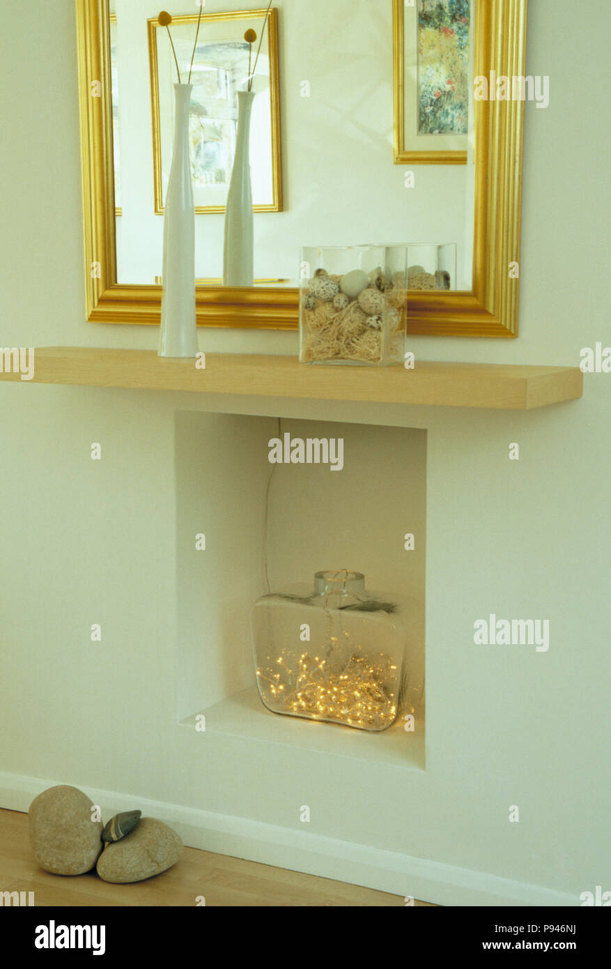 Shelf Above Fireplace Alcove With Fairy Lights In Glass Vase Stock