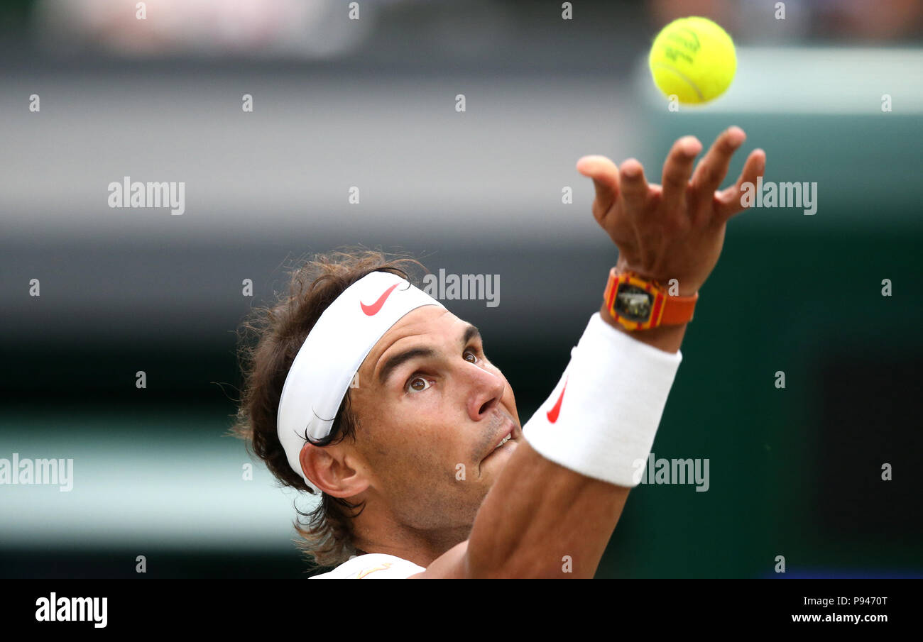 Rafael Nadal serves on day twelve of the Wimbledon Championships at the All England Lawn Tennis and Croquet Club, Wimbledon. Stock Photo