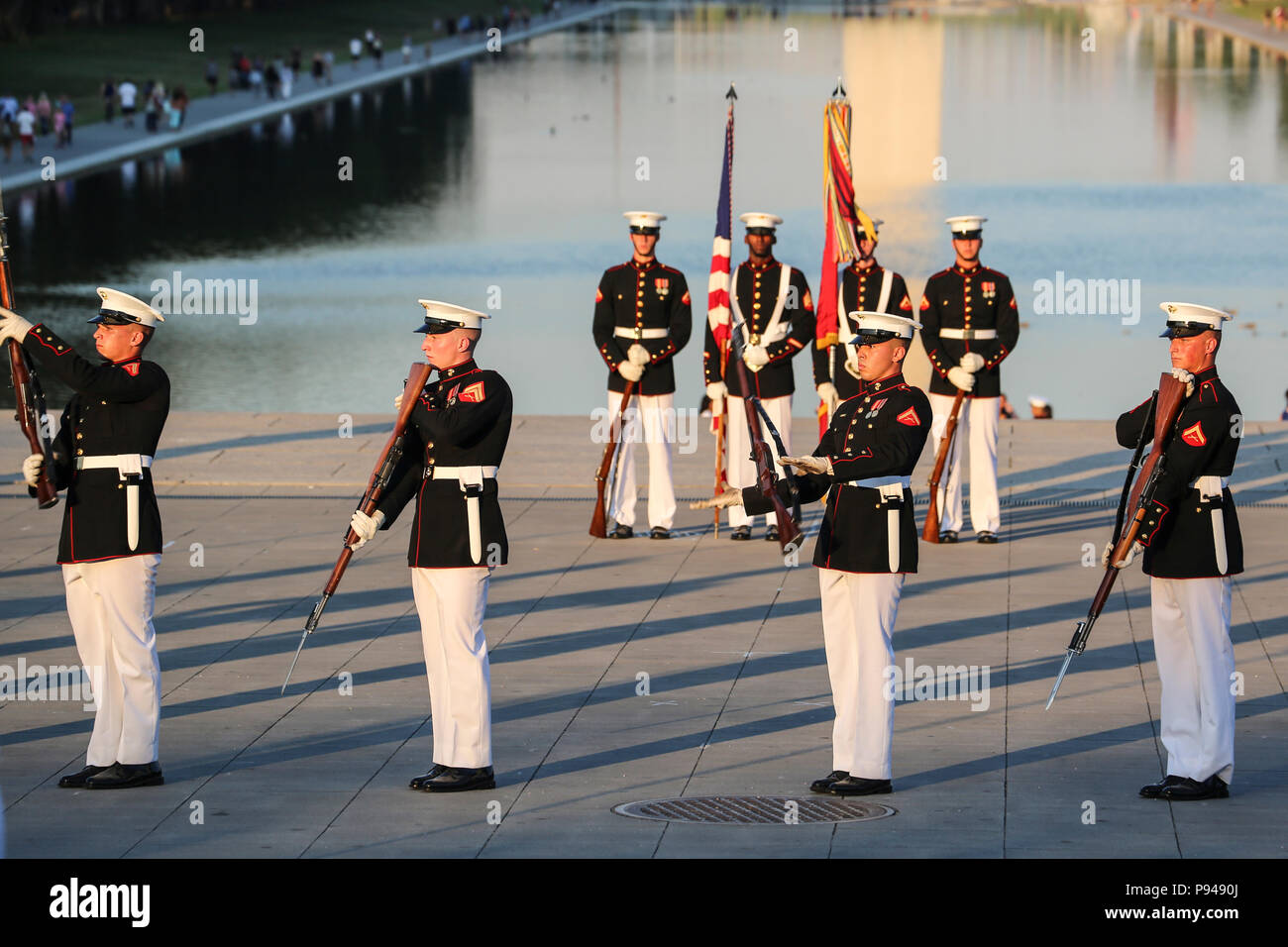 Marines with the U.S. Marine Corps Silent Drill Platoon execute precision rifle drill movements during a Tuesday Sunset Parade at the Lincoln Memorial, Washington D.C., July 10, 2018. The guest of honor for the parade was the former Vice President of the U.S., Joe Biden, and the hosting official was the Staff Judge Advocate to the Commandant of the Marine Corps, Maj. Gen. John R. Ewers Jr. (Official Marine Corps photo by Cpl. Damon Mclean/Released) Stock Photo