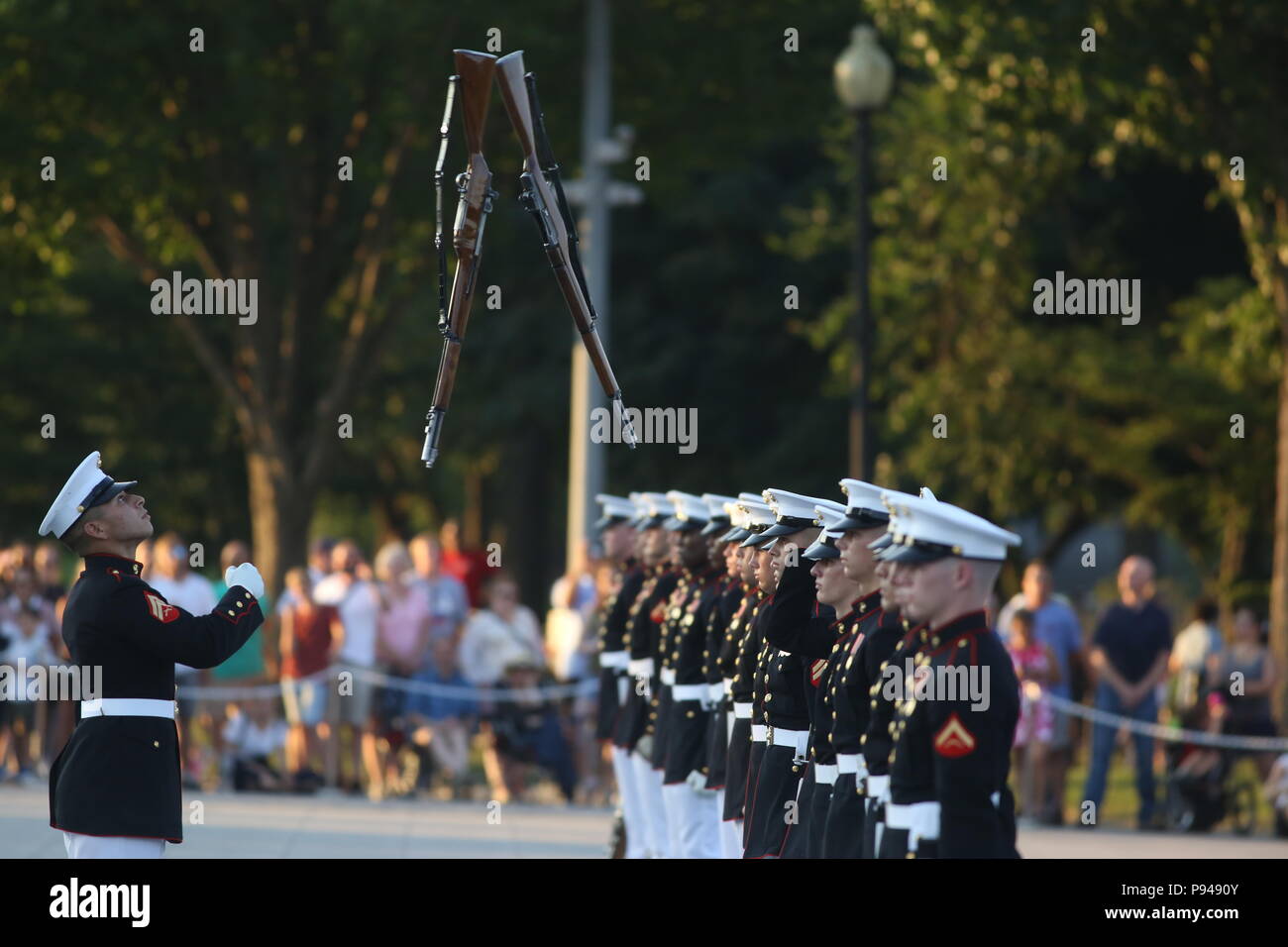 Corporal Christopher Ochoa, rifle inspector, U.S. Marine Corps Silent Drill Platoon, prepares to catch a rifle during a Tuesday Sunset Parade at the Lincoln Memorial, Washington D.C., July 10, 2018. The guest of honor for the parade was the former Vice President of the U.S., Joe Biden, and the hosting official was the Staff Judge Advocate to the Commandant of the Marine Corps, Maj. Gen. John R. Ewers Jr. (Official Marine Corps photo by LCpl Bourgeois/Released) Stock Photo