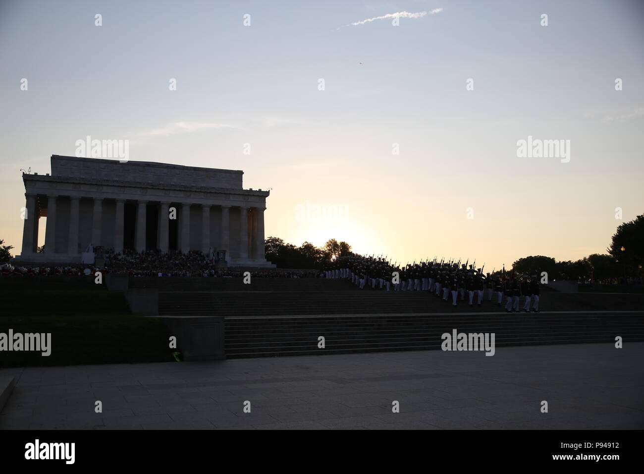 Alpha and Bravo marching companies with Marine Barracks Washington D.C., march off the parade deck at the conclusion of a Tuesday Sunset Parade at the Lincoln Memorial, Washington D.C., July 10, 2018. The guest of honor for the parade was the former Vice President of the U.S., Joe Biden, and the hosting official was the Staff Judge Advocate to the Commandant of the Marine Corps, Maj. Gen. John R. Ewers Jr. (Official Marine Corps photo by Cpl. Damon Mclean/Released) Stock Photo