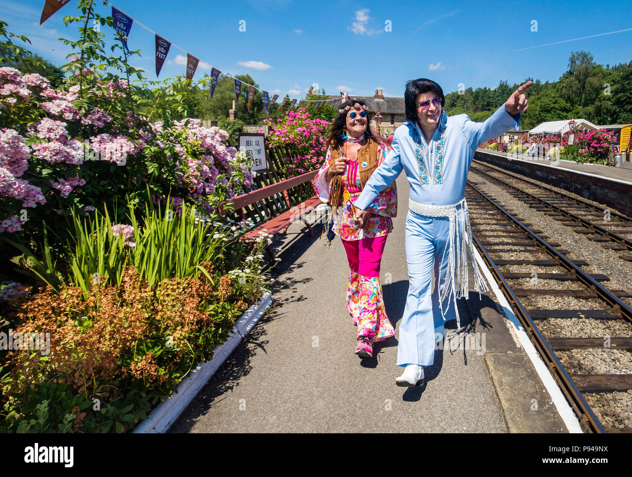 Susanne Lende with Elvis tribute artist Steve Caprice during the North Yorkshire Moors Railway 60s Fest 2018 at Levisham station in Yorkshire. Stock Photo