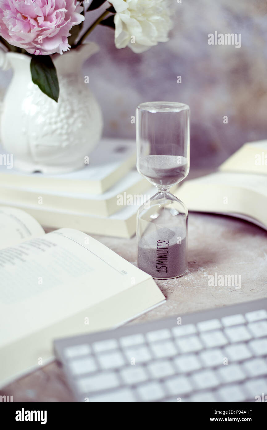 Time passing concept,urgency and running out of time. Sand fall in hourglass Stock Photo
