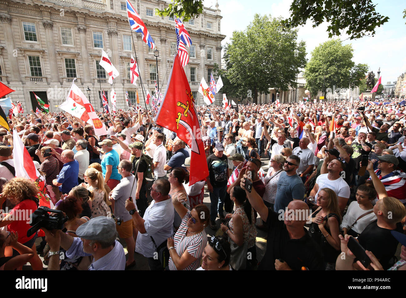 Free Tommy Robinson supporters and Pro-Trump supporters come together on Whitehall, London for a joint rally in support of the visit of the US President to the UK and calling for the release of jailed Tommy Robinson. Stock Photo