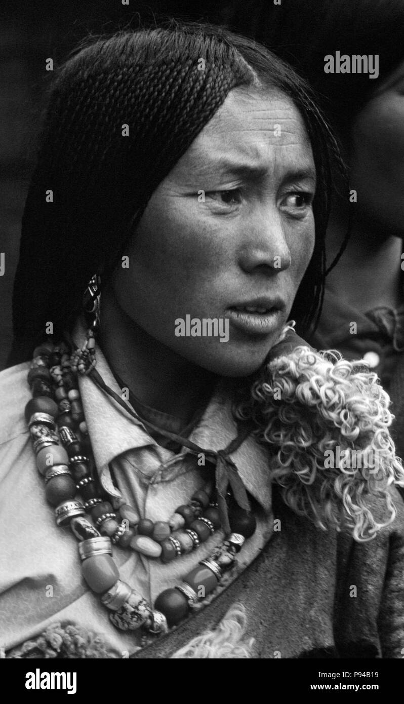 Tibetan pilgrim woman with beautiful jewelry & traditional 108 braids at Sera Monastery - Lhasa, Tibet Stock Photo