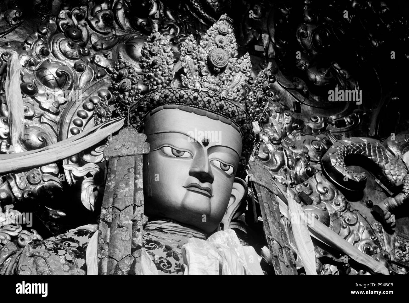 Beautiful JEWEL ENCRUSTED STATUE OF MAITREYA (future Buddha) in the MAIN ASSEMBLY HALL at DREPUNG MONASTERY Stock Photo