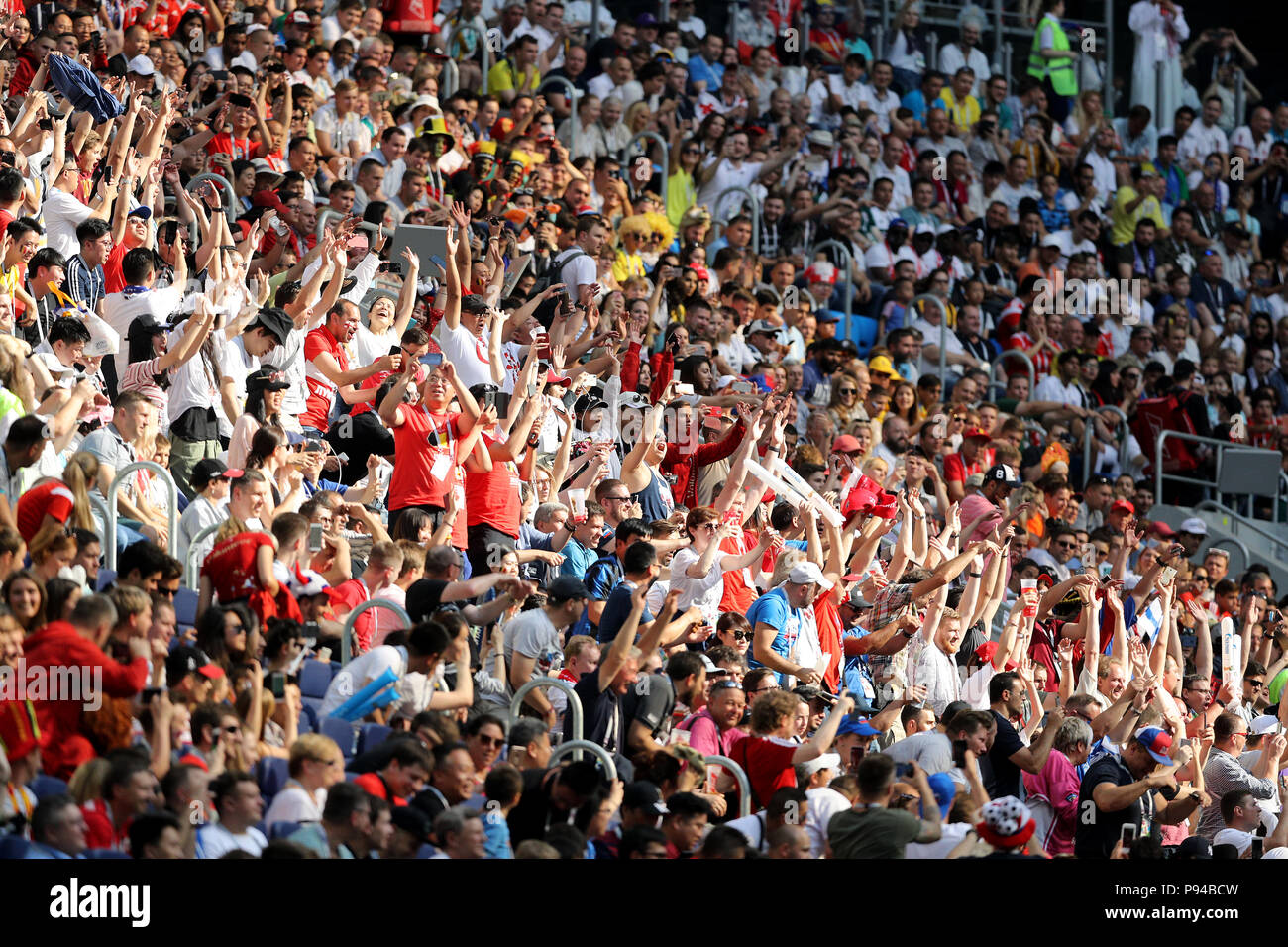 Football fans take part in a Mexican Wave in the stands during the FIFA
