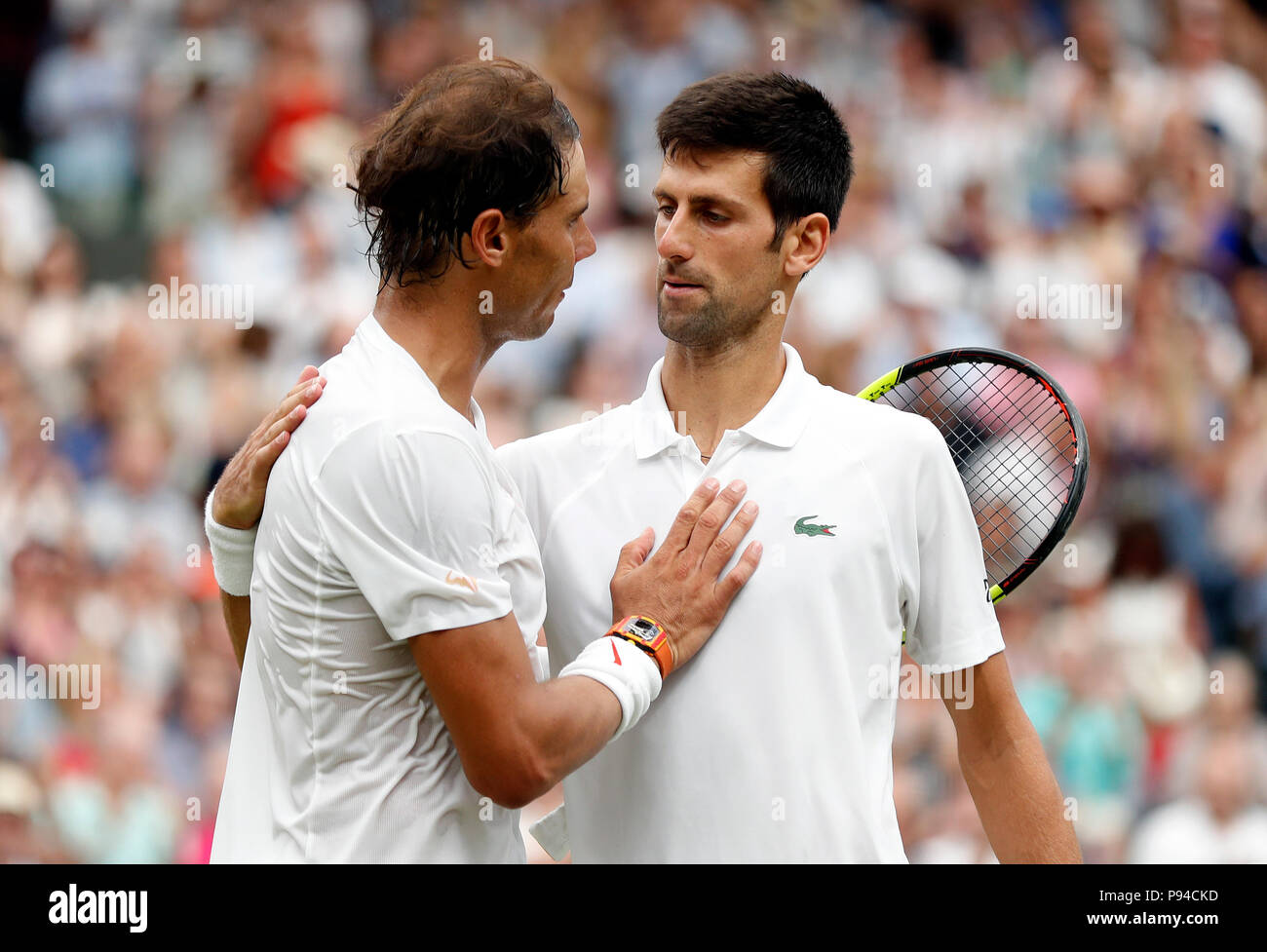 Novak Djokovic (right) and Rafael Nadal embrace at the net after their  match on day twelve of the Wimbledon Championships at the All England Lawn  tennis and Croquet Club, Wimbledon Stock Photo -