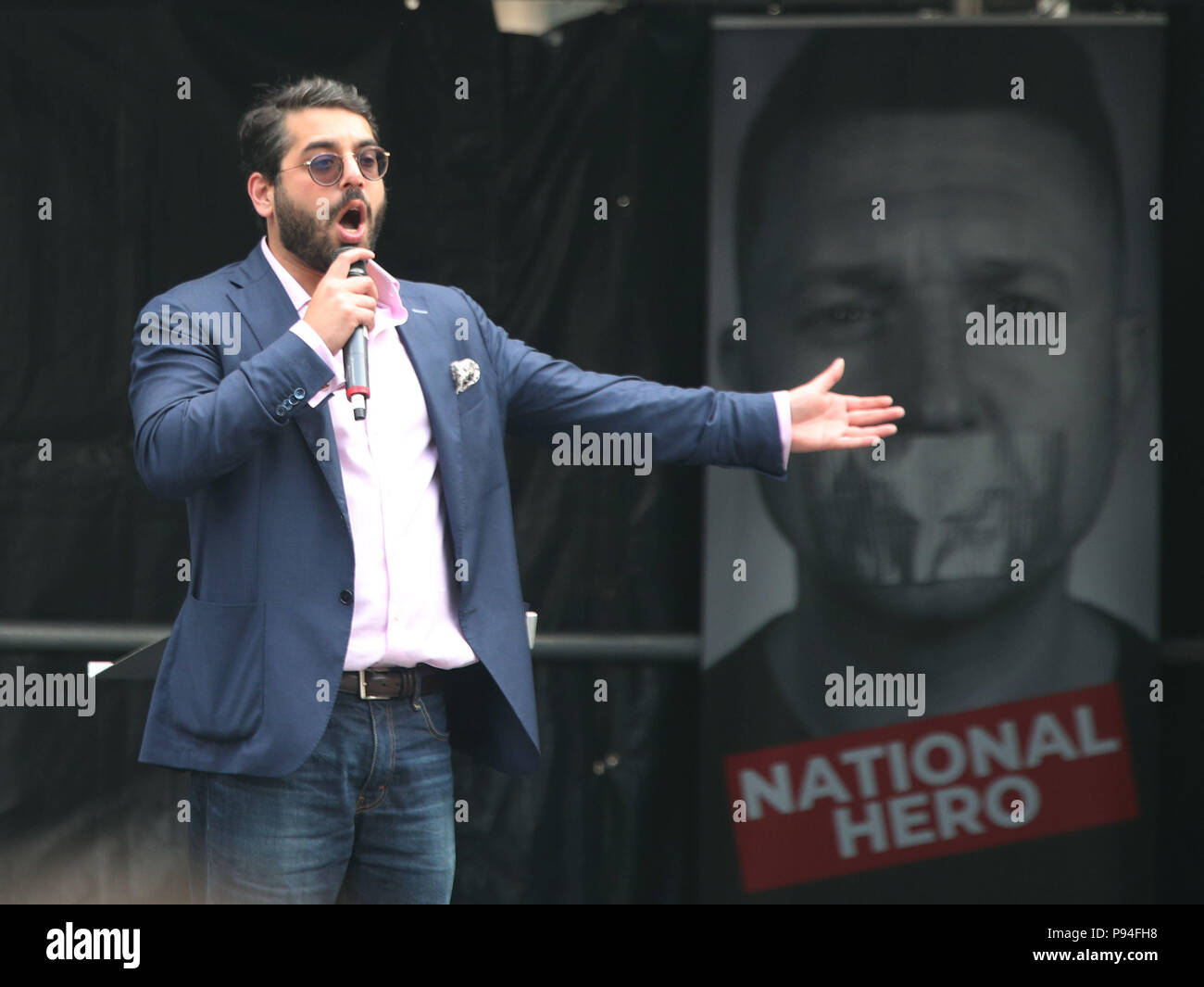Raheem Kassam, former chief advisor to UK Independence Party leader Nigel Farage, and former editor-in-chief of Breitbart News London, on stage during a Free Tommy Robinson and Pro-Trump joint rally Whitehall, London, suporting the visit of the US President Donald Trump to the UK and calling for the release of jailed Tommy Robinson. Stock Photo