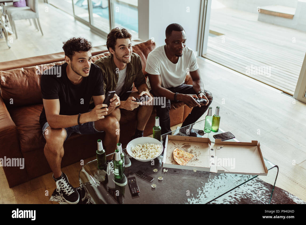 Two men holding up bottles hi-res stock photography and images - Alamy