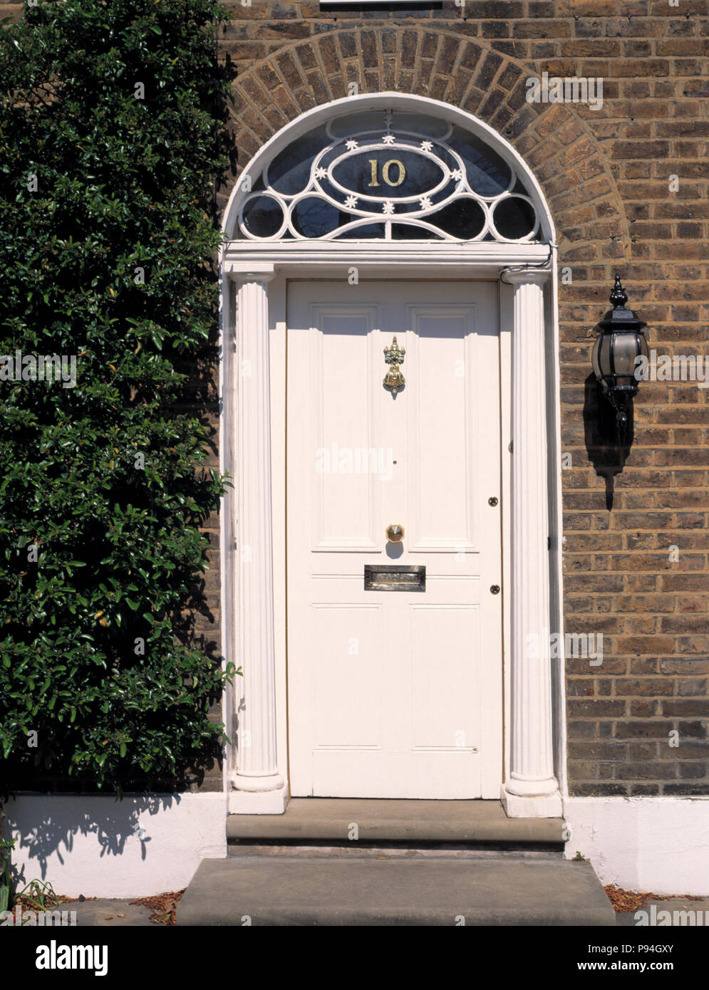Newly painted white front door in Victorian terraced house Stock Photo