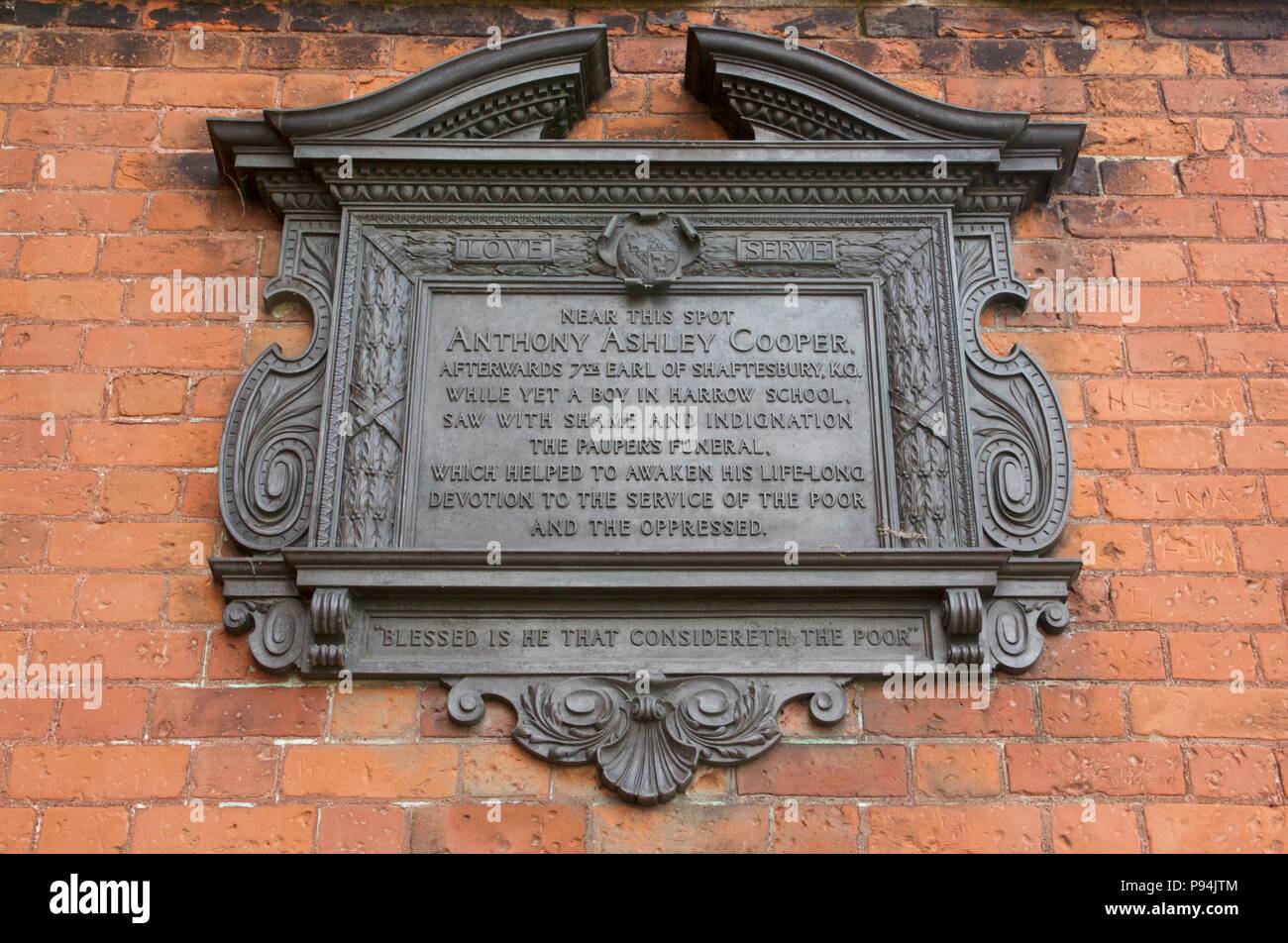 A black, decorative plaque on Harrow-On-The-Hill for Anthony Ashley Cooper, the 7th Earl of Shaftesbury, who attended Harrow School as a boy Stock Photo