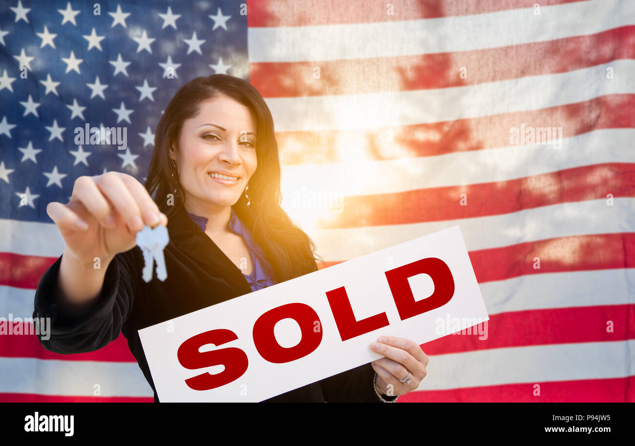 Hispanic Woman House Keys and Sold Sign In Front of American Flag Stock ...