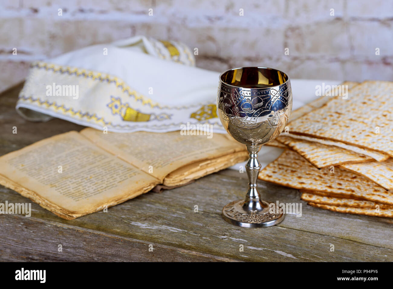 Jewish holidays Passover Pesach matzah and silver cup full of wine with a traditional blessing kiddush cup of wine Stock Photo