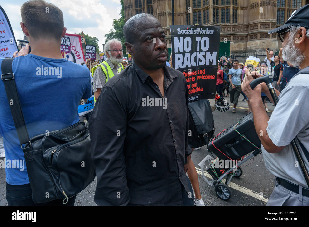 London, UK. 14th July 2018.  A furious Weyman Bennett marches to Whitehall after police have refused to allow the larry with the sound equipment to go to the rally there to peacefully oppose the protest by right-wing groups supporting the campaign to free jailed former EDL leader Tommy Robinson and support President Trump. Credit: Peter Marshall/Alamy Live News Stock Photo