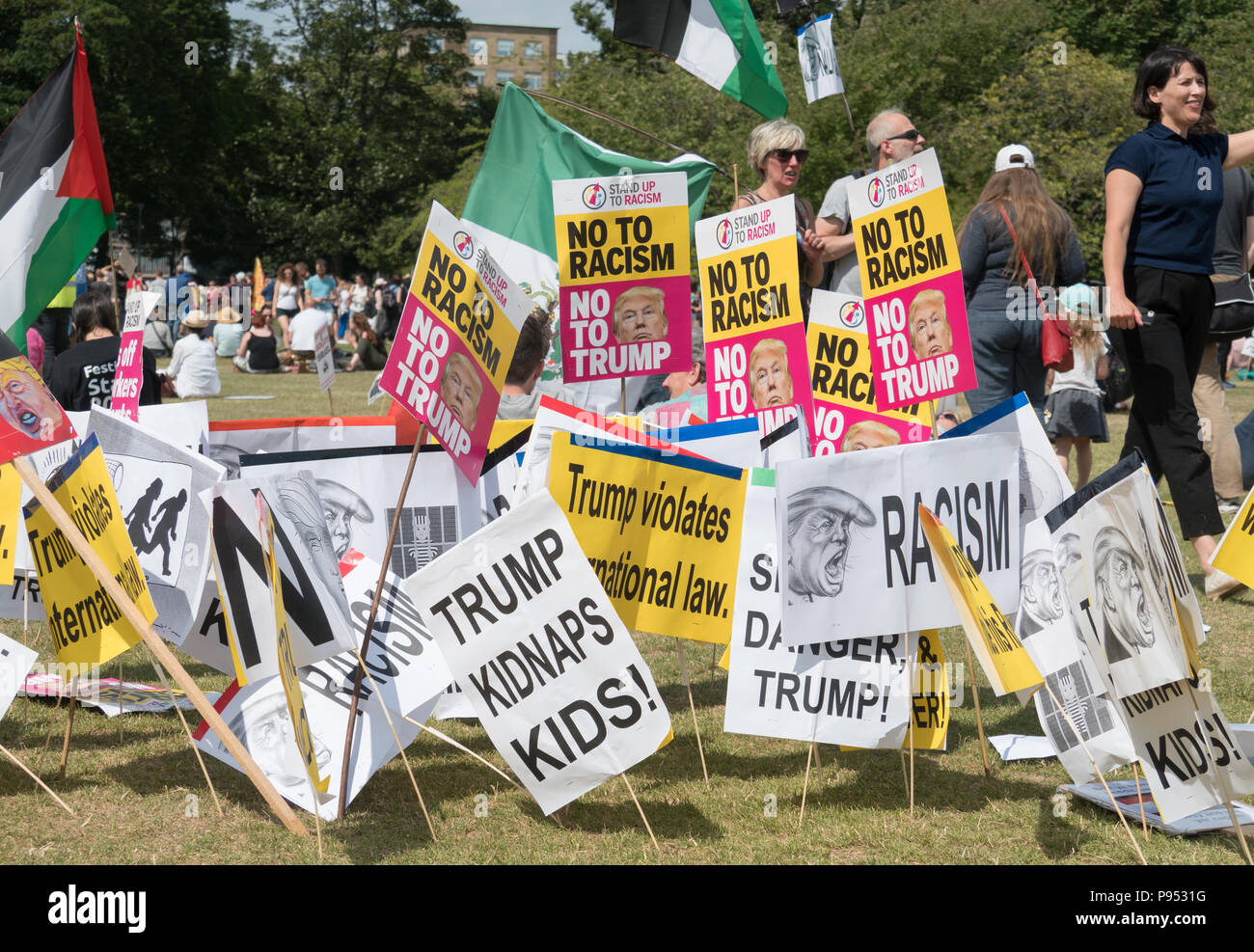 Scotland, UK. 14th July 2018. Anti Donald Trump 'festival of resistence' showing banners protesting USA president DonaldTrump's policies, also some flags. Taken at The Meadows in Edinburgh, Scotland, United Kingdom. Credit: Dallas Carter/Alamy Live News Stock Photo