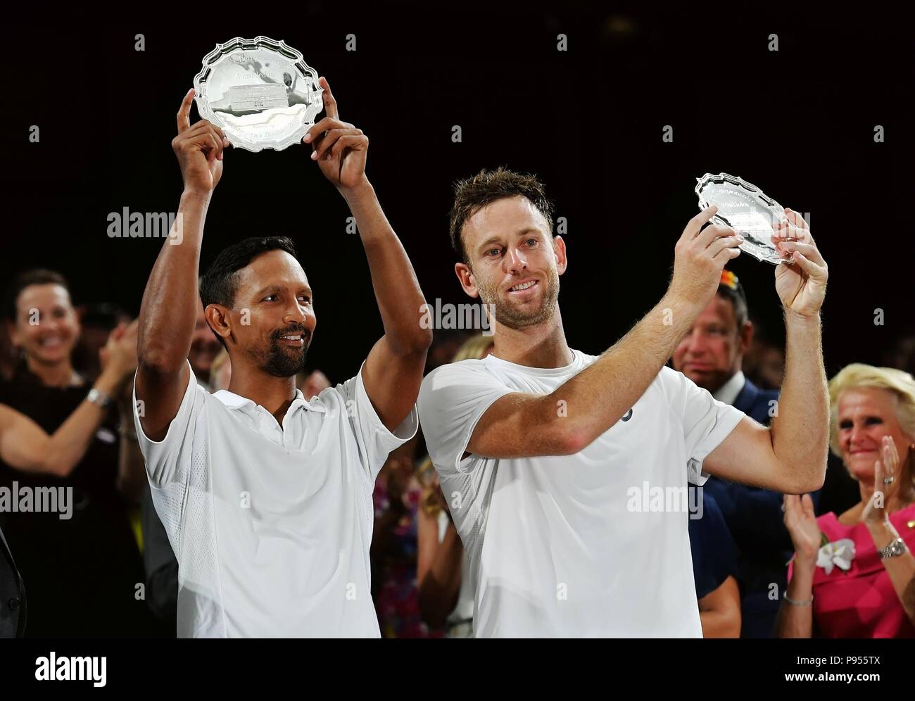 London, Britain. 14th July, 2018. Michael Venus (R) of New Zealand and Raven Klaasen of South Africa show their trophies after the Gentlemen's Doubles Final against Mike Bryan and Jack Sock of the United States at the Wimbledon Championships 2018 in London, Britain, on July 14, 2018. Michael Venus and Raven Klaasen lost 2-3 and won the second place of the event. Credit: Guo Qiuda/Xinhua/Alamy Live News Stock Photo