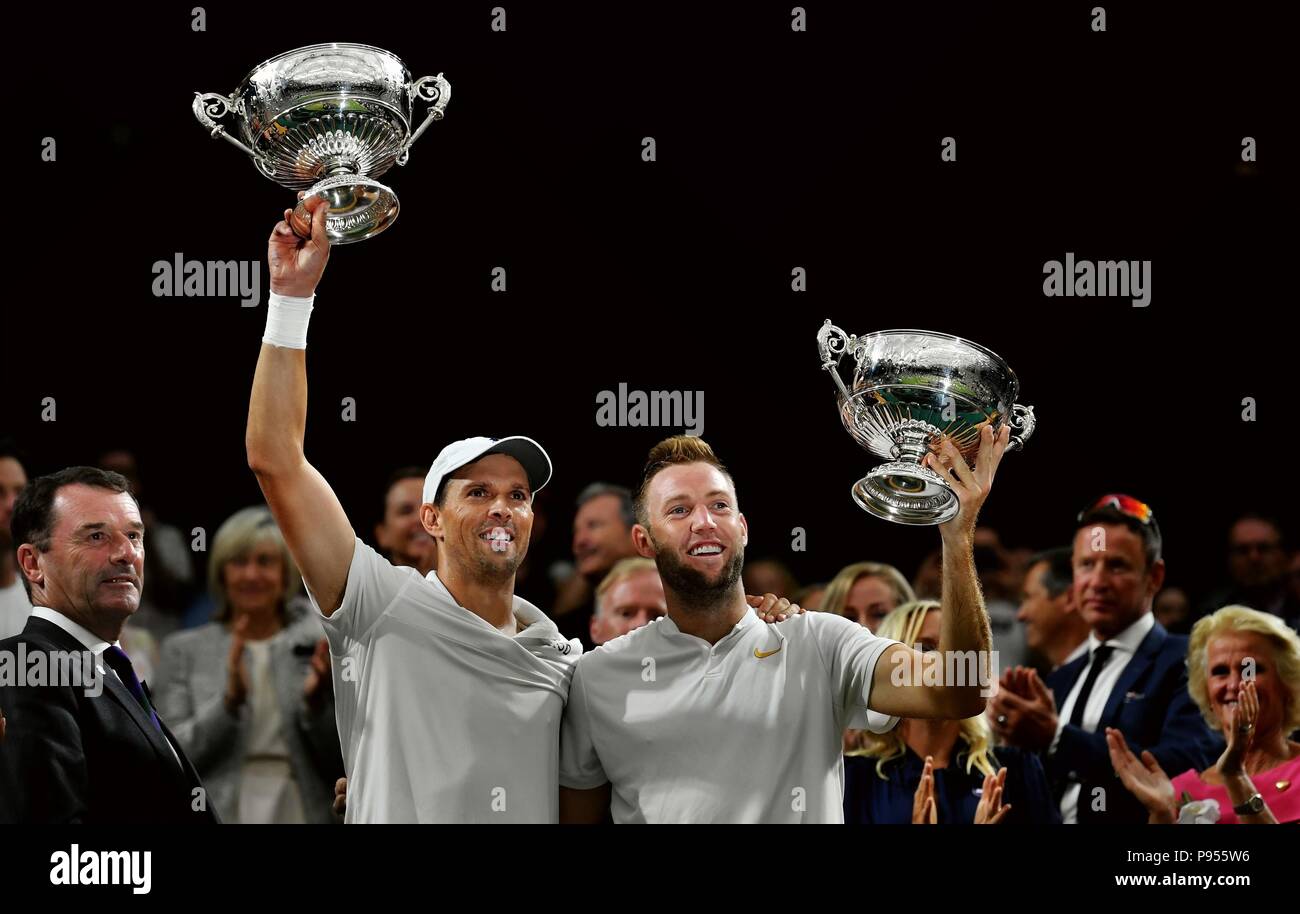 London, Britain. 14th July, 2018. Mike Bryan (L) and Jack Sock of the United States show their trophies after the Gentlemen's Doubles Final against Michael Venus of New Zealand and Raven Klaasen of South Africa at the Wimbledon Championships 2018 in London, Britain, on July 14, 2018. Mike Bryan and Jack Sock won 3-2 and claimed the champion. Credit: Guo Qiuda/Xinhua/Alamy Live News Stock Photo