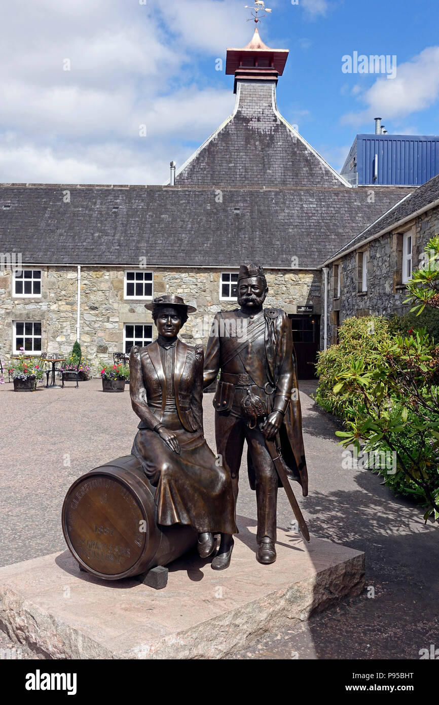 Glenfiddich Whisky Distillery in Dufftown Moray Scotland with statue of William and Elisabeth Grant founders of the distillery Stock Photo