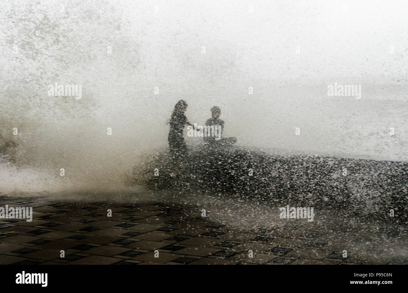 Mumbai, India. 13th July, 2018. Children enjoy high tide in Mumbai, Maharashtra, India Credit: Indranil Aditya/Pacific Press/Alamy Live News Stock Photo