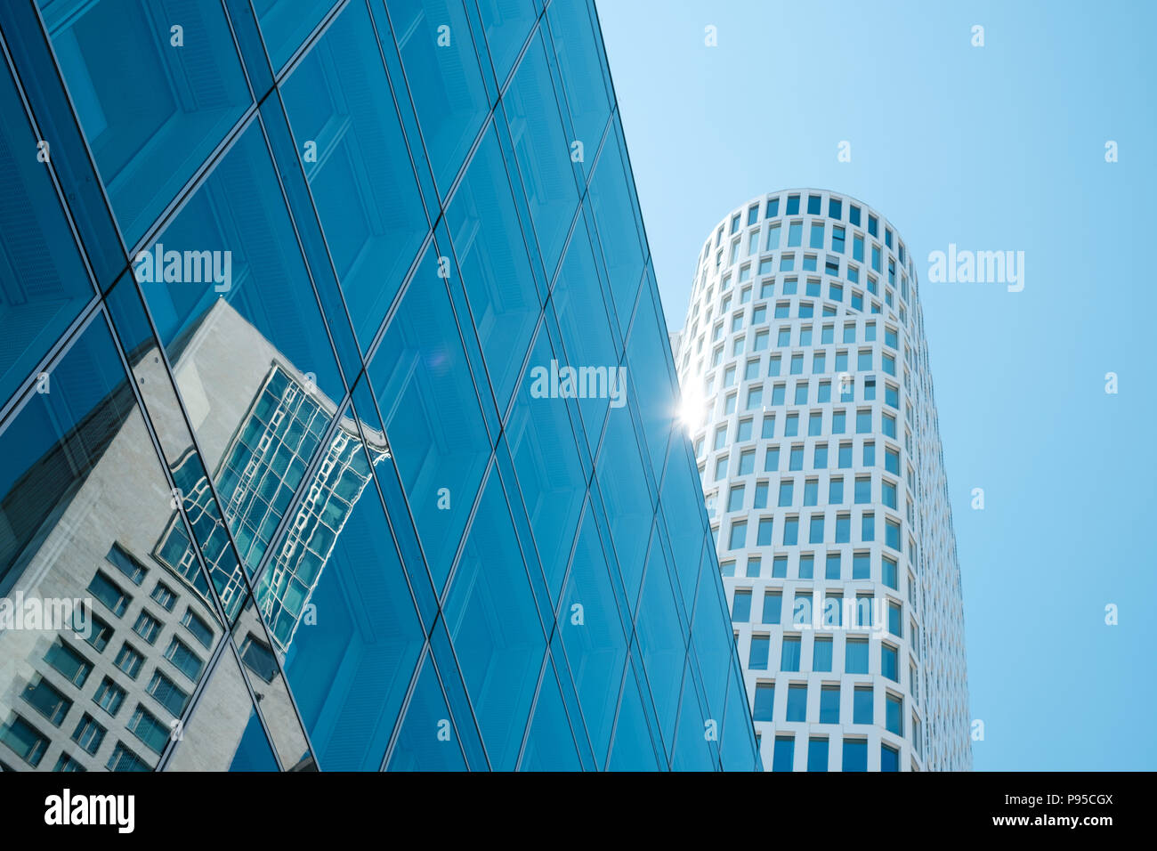 glass facade of modern office with skyscraper building reflection and ...