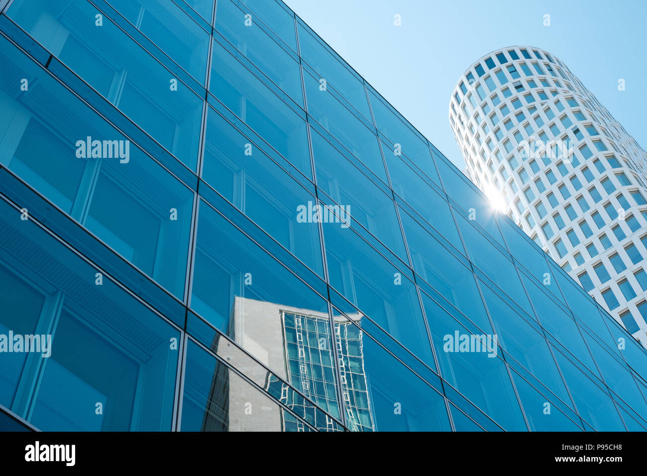 glass facade of modern office with skyscraper building reflection and ...
