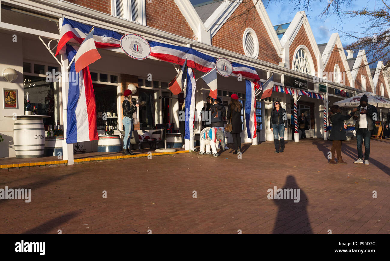 Franschhoek shopping strip and shop exteriors decorated in French flags and banners with people outside on Bastille Day 14th July 2018 Stock Photo