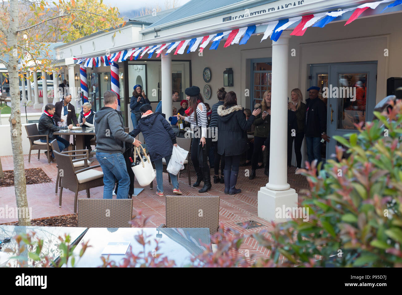 crowd of people outdoors at pub restaurant enjoying the Bastille Day celebration in Franschhoek, Cape Town, South Africa 14th July 2018 Stock Photo