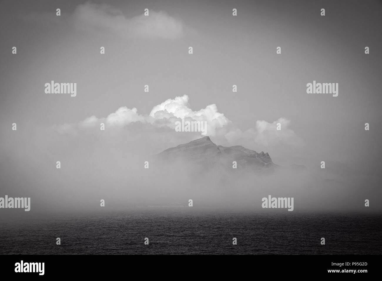 Crest of a hill being revealed behind the cloud over the sea from the Isle of Skye Stock Photo