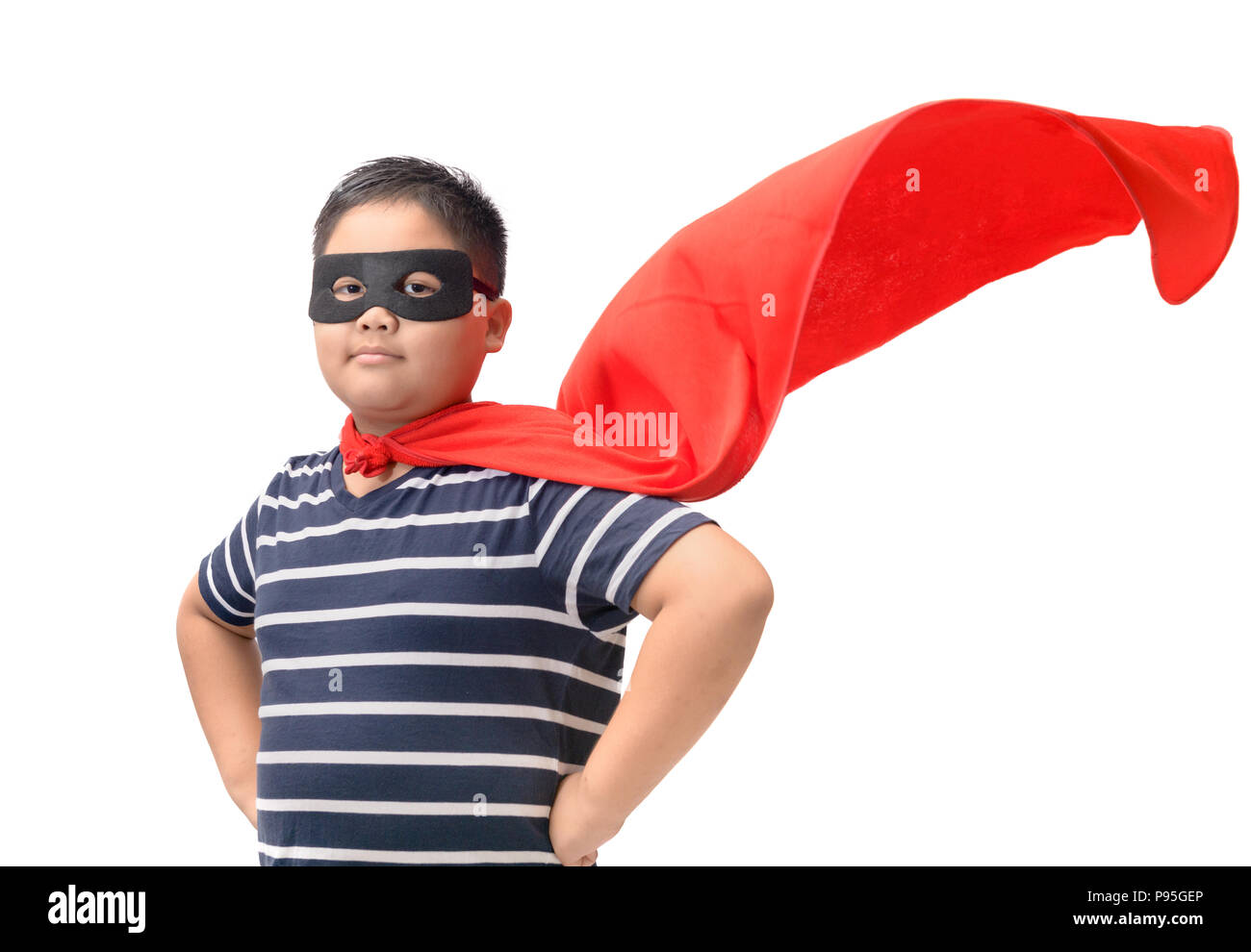 Fat child plays superhero isolated on white background, Boy power concept. Stock Photo