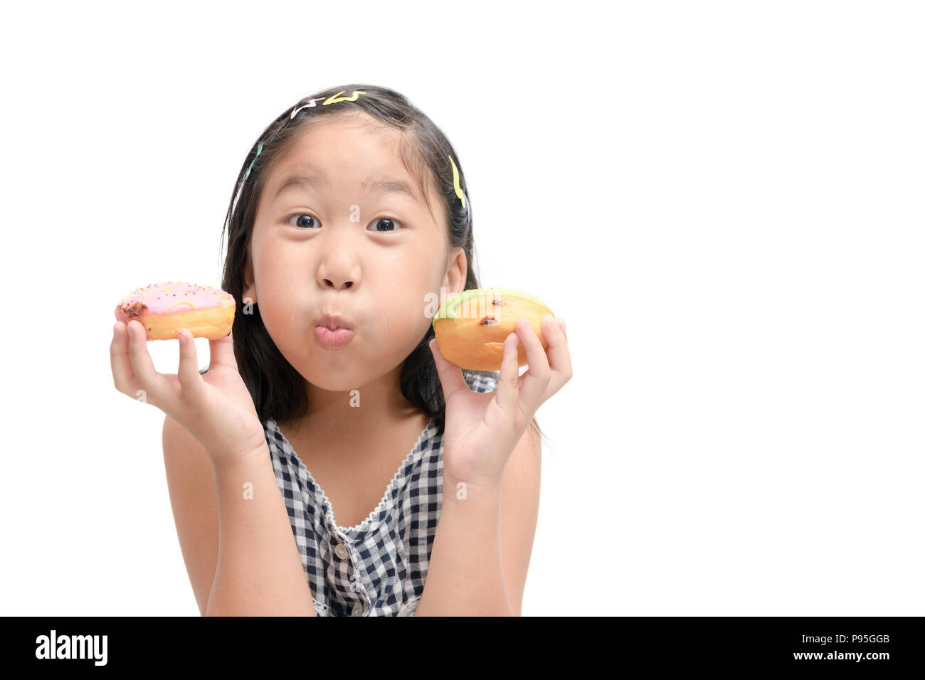 Happy cute girl is eating donut isolated on white background. Stock Photo