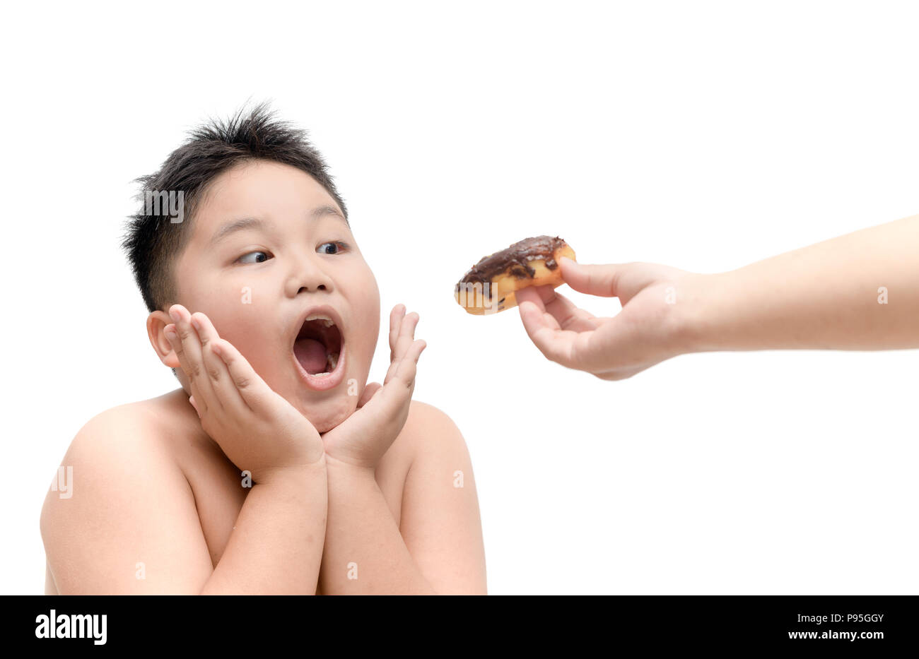 Obese fat boy is eating donut from mother hand isolated on white background, junk food and dieting concept Stock Photo