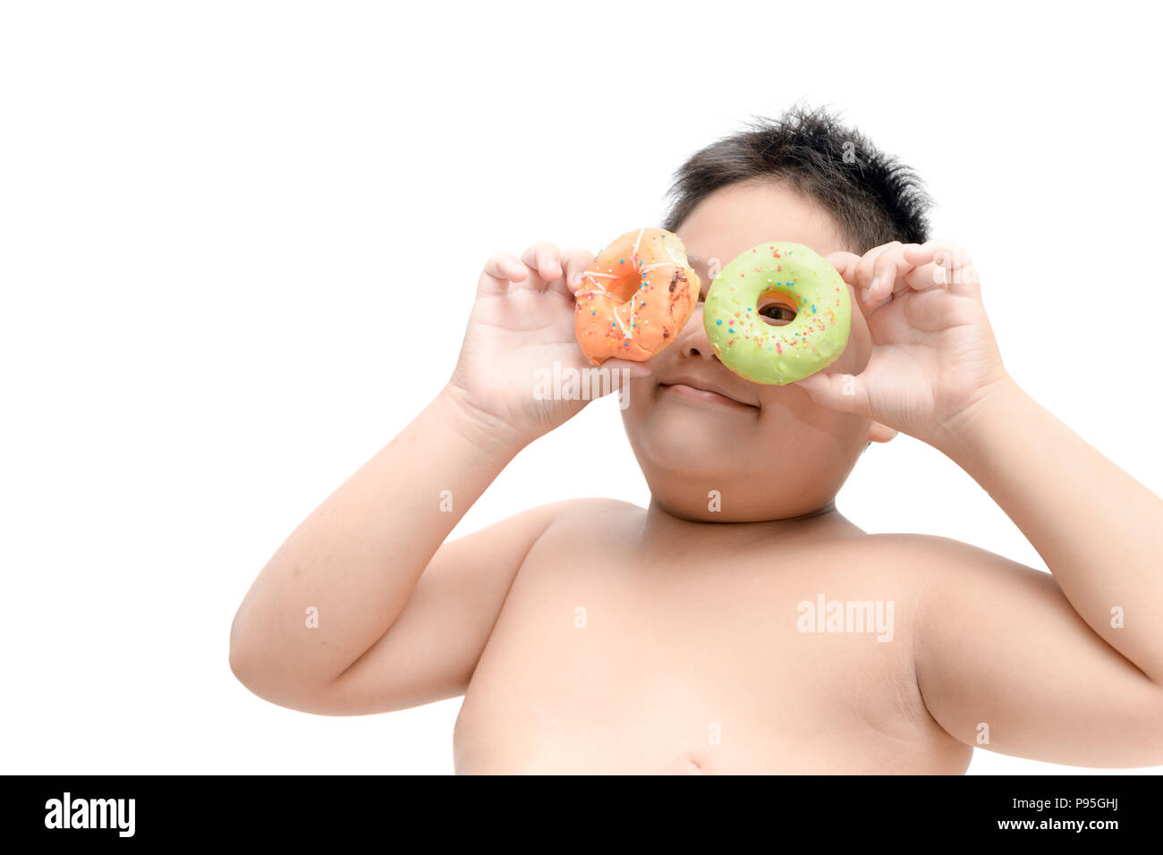 Obese fat boy is eating donut isolated on white background, junk food and dieting concept Stock Photo